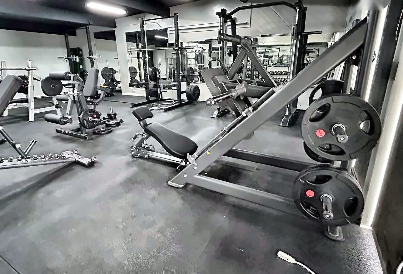 Inside the Sweat Equity TC studio — weight machines and equipment