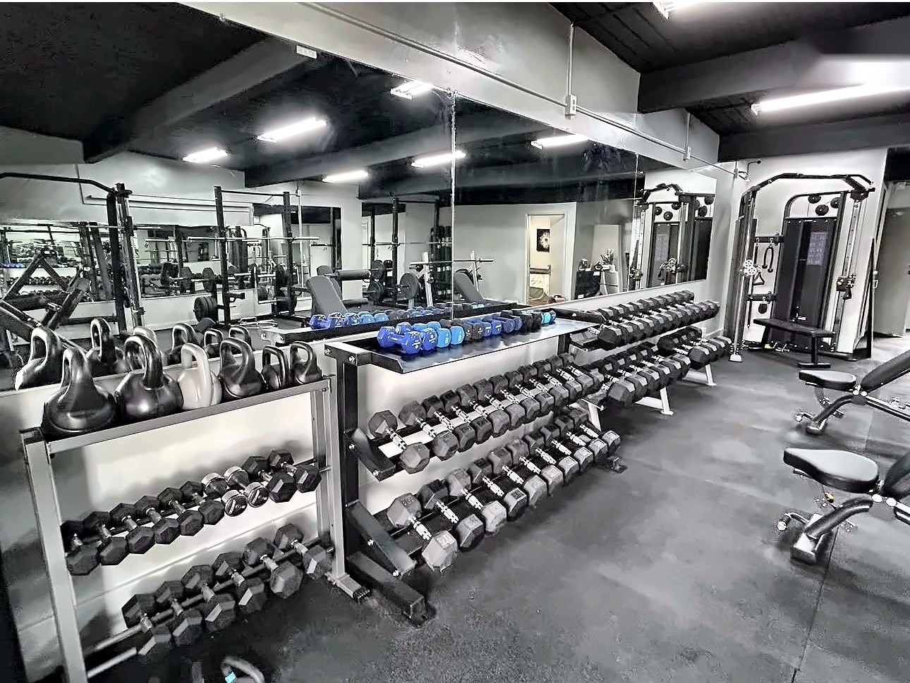 Inside the Sweat Equity TC studio — dumbbell and kettlebell rack